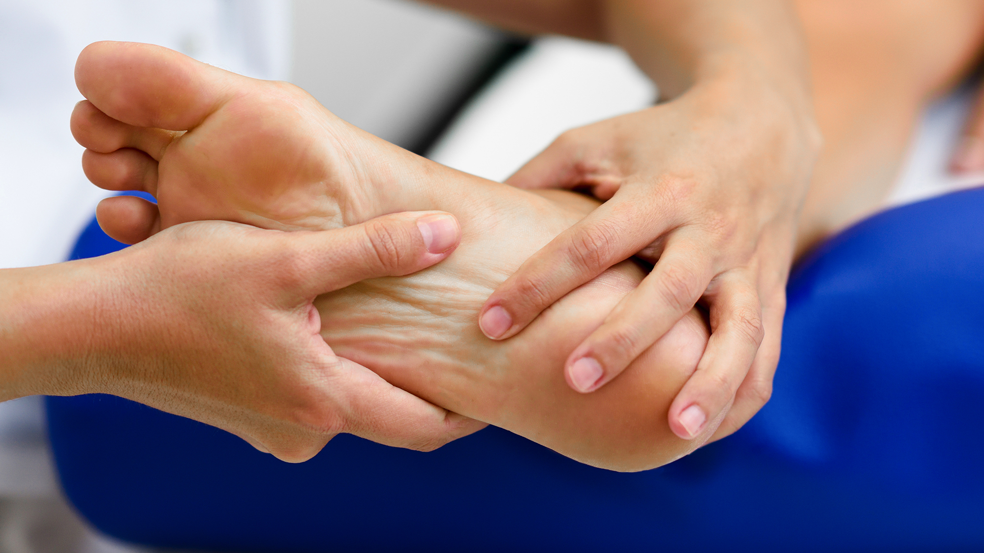 Chiropodist examining a foot